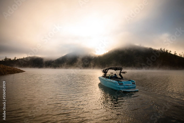 Fototapeta Great view on modern motor boat floating on water. Scenic view on the background