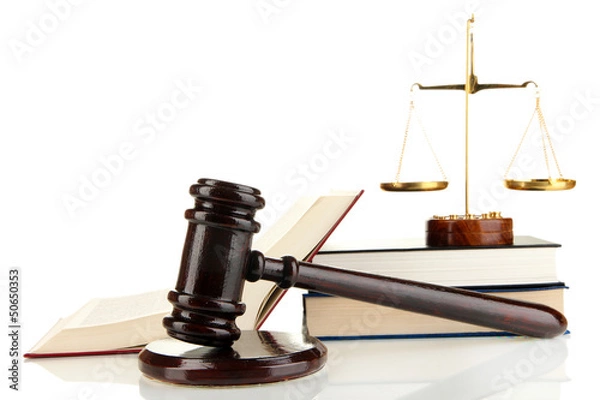Fototapeta Golden scales of justice, gavel and books isolated on white