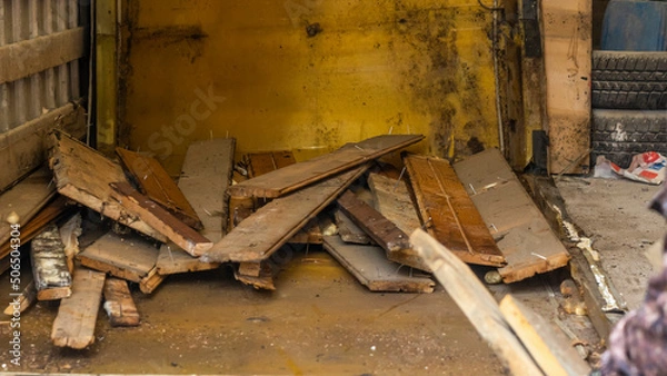 Fototapeta Removal of construction debris. Loading the garbage can waste construction trash dumpsters on house renovation.