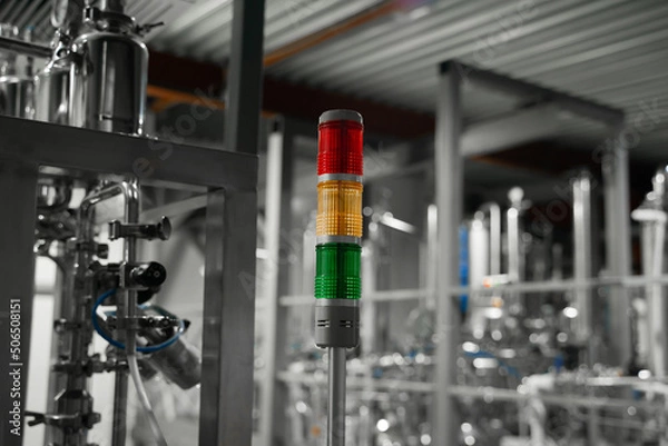 Fototapeta Industrial tower signal lights indicate the error status of the production line. Stack lights in automated production module in factory