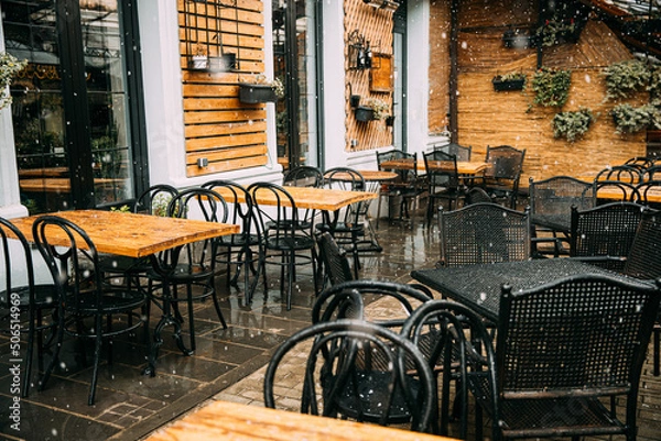 Obraz Tables, empty cafe during bad cold weather. nobody in Cafe. Free Tables, empty cafe during bad cold weather.