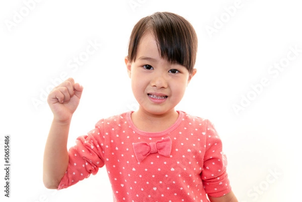Fototapeta ガッツポーズをする笑顔の女の子
