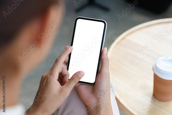 Obraz close-up a woman holding and touch smartphone blank screen