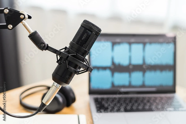 Fototapeta Condenser microphone in recording home studio. Content creator working with laptop host streaming radio podcast interview conversation at home broadcast studio recording waveform voice over radio