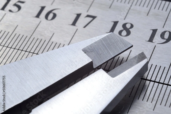 Fototapeta Accurate measuring tool caliper and metal ruler lie on top of each other. close-up.