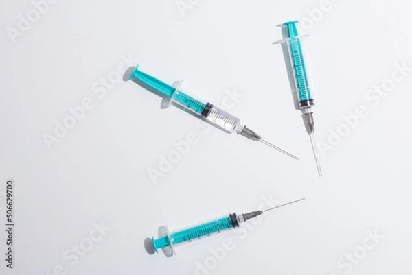 Fototapeta Medical syringe on a white background. A syringe for injection. The concept of health and beauty