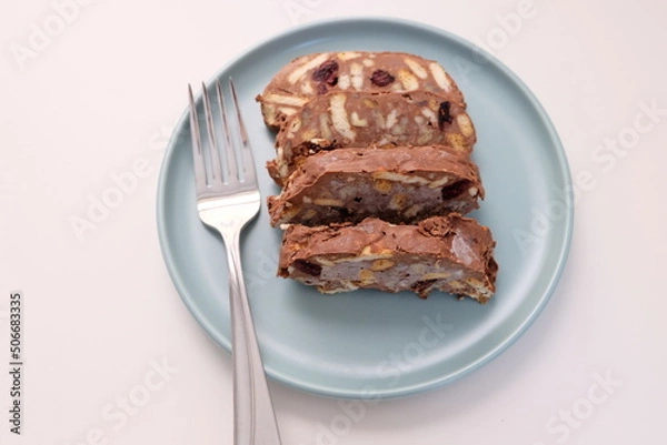 Fototapeta Homemade mosaic chocolate biscuit cake served in a blue plate, selective focus. It is called "Mozaik Pasta" in Turkish. That is texture of it not grain. Traditional Turkish dessert.