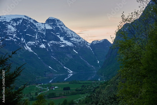 Fototapeta Briksdalasbreen glacier. Sunset. Glacier waterfall. Sheep. Authentic Norwegian house. Spring in Norway. Jostedalsbreen National Park.
