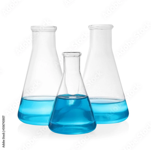 Fototapeta Different laboratory glassware with light blue liquid on white background