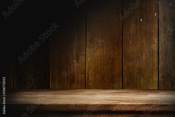 Fototapeta Wooden table in dark room background concept for advertising.
