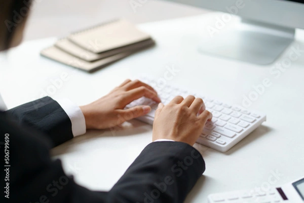 Fototapeta Business woman sitting using laptop computer with on the desk in the office.