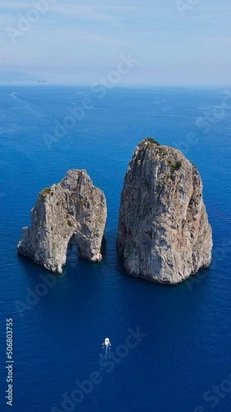 Obraz Aerial view of Capri, an island located in the Tyrrhenian Sea off the Sorrento Peninsula, on the south side of the Gulf of Naples in the Campania region of Italy. Drone view of Faraglioni di Capri.