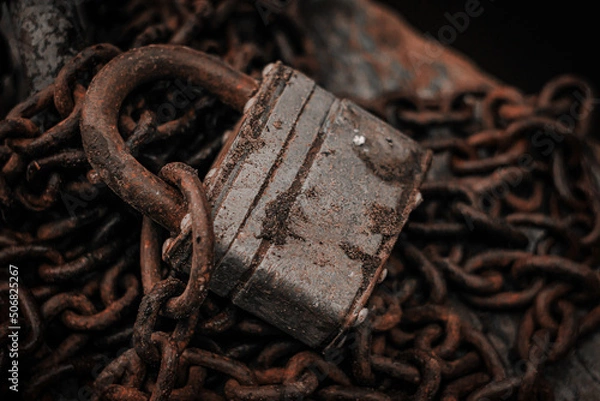 Obraz Old padlock on a rusty chain close-up. The concept of protection, safety, security.