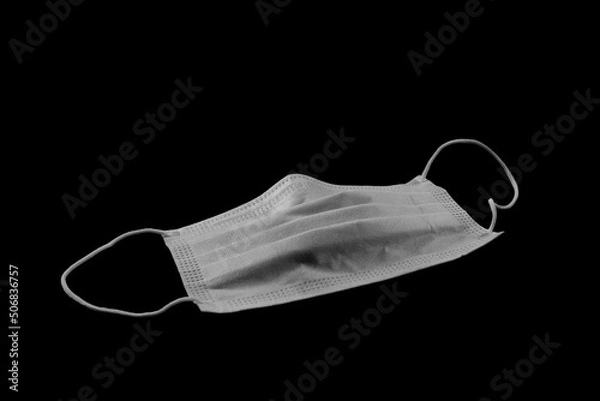 Obraz Medical mask isolated on black background. Respirator on the table. Coronavirus mask. 