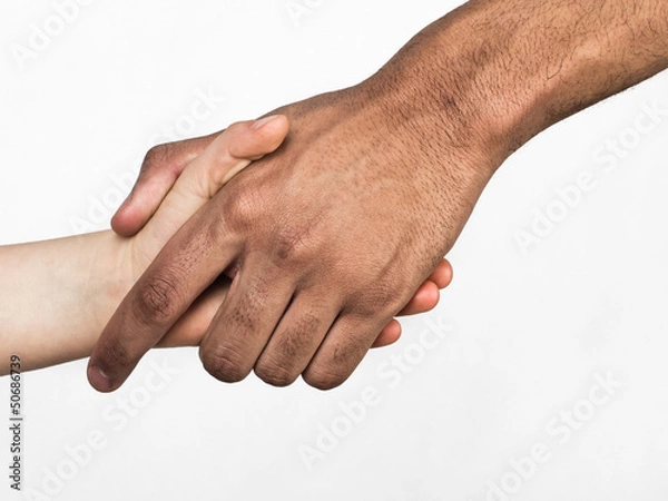 Fototapeta Handshake between white child and black man