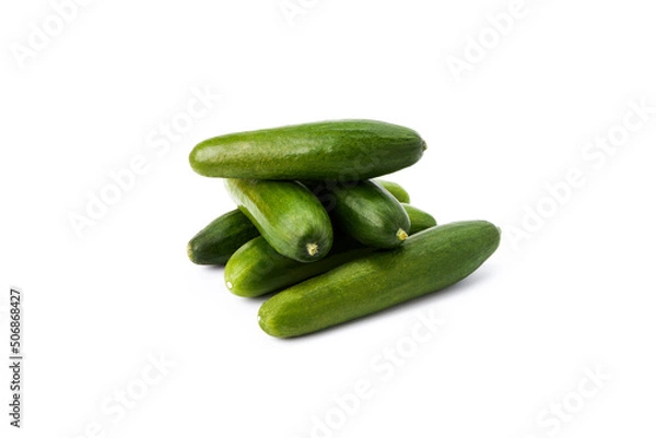 Fototapeta Stack tasty mini green cucumbers on a white background