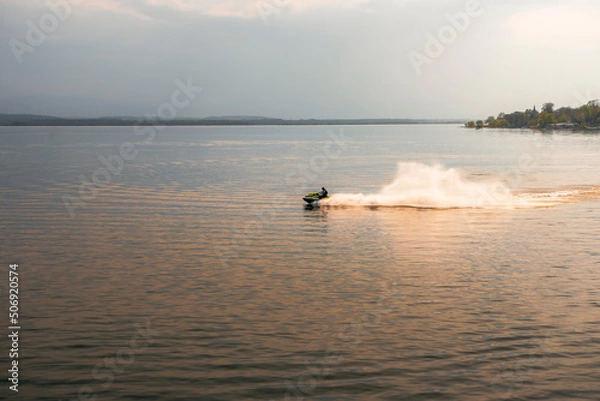 Fototapeta A water scooter floating on the lake in Nysa at sunset