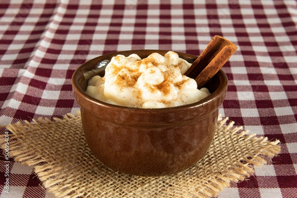 Obraz traditional sweet from the Brazilian June festivals, made of white corn with coconut and condensed milk and sprinkled with cinnamon