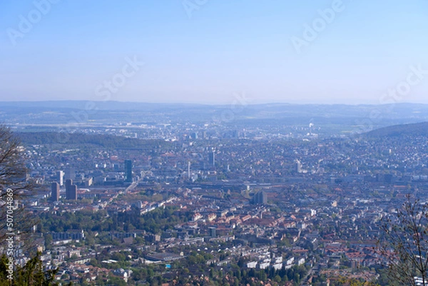 Fototapeta Aerial view over City of Zürich on a beautiful spring day with blue cloudy sky background. Photo taken April 21st, 2022, Zurich, Switzerland.