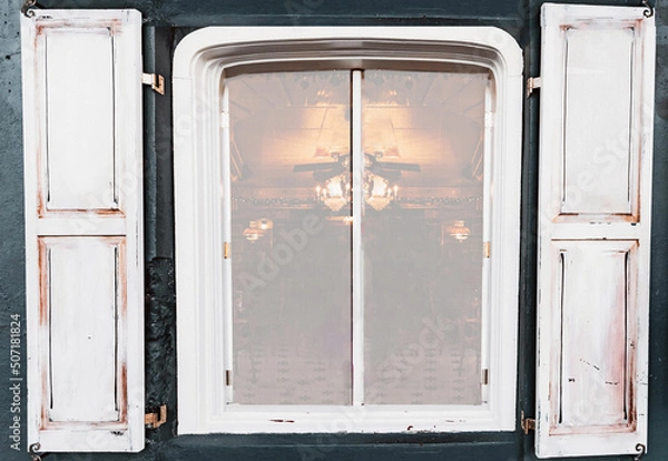 Obraz Old and weathered vintage window with faded soft light glowing and an air of atmospheric moody ambiance peeking through.