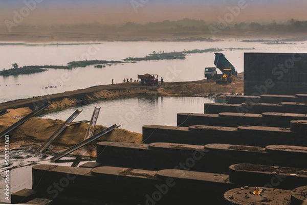 Obraz In a dam tractor and dumper working.