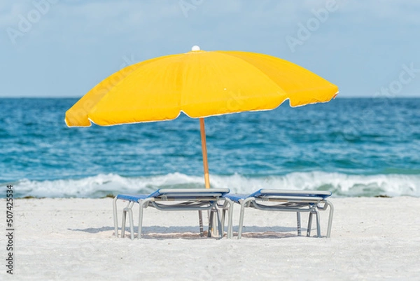 Obraz Yellow umbrella and lounge chairs on the beach