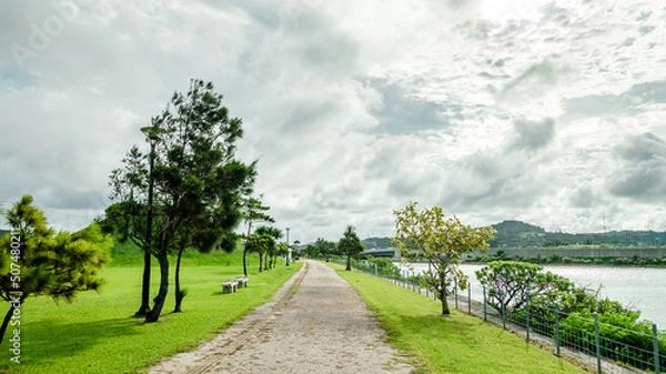 Fototapeta Park walkway by the canal