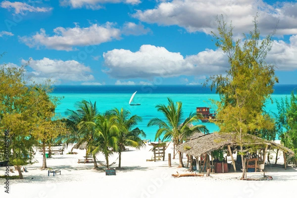 Obraz Beautiful tranquil empty bright white paradise sand beach, sun beds, palm trees, bamboo hut bar, turquoise water - Paje, Zanzibar