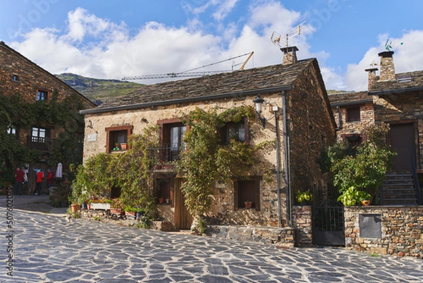 Obraz Typical house from the northern mountains of Guadalajara (Spain) with a slate roof, stone walls with vegetation.