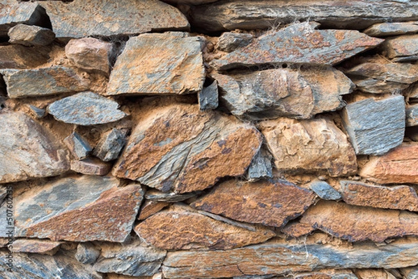 Fototapeta Rectangular stone wall in ocher tones