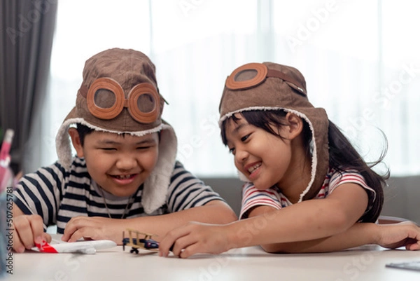 Fototapeta Two children with airplanes in hands