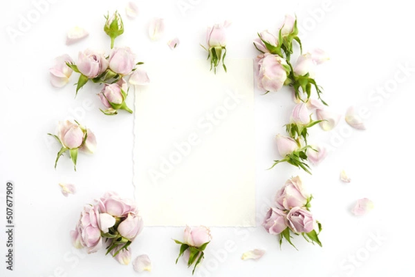 Obraz Framework from roses and petals on white background. Flat lay.