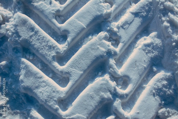 Fototapeta Excavator tire tracks in the surface snow, winter tire