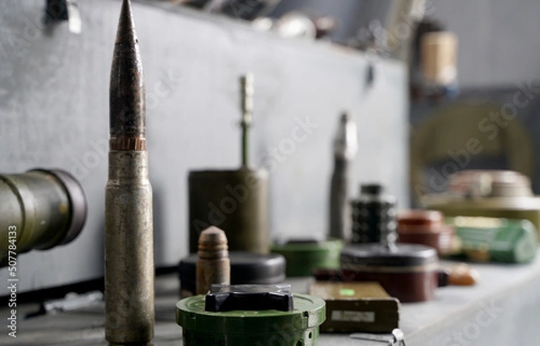 Fototapeta Lots of shells and rockets of war in Ukraine. Grenades, ATGMs, cruise missiles. Anti-personnel mine. Territory cleared. Demining by troops of the territory.