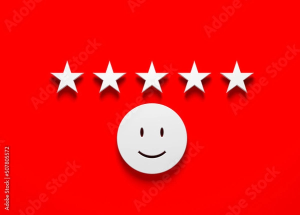 Fototapeta Feedback concept white color stars and emoticon on red color background. Horizontal composition with copy space. Isolated with clipping path.