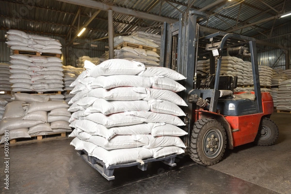 Obraz Forklift in a warehouse with wheat in sacks