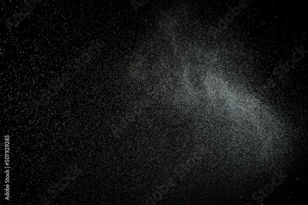 Obraz Sprayed water. Splashes and drops of water isolated on black background.