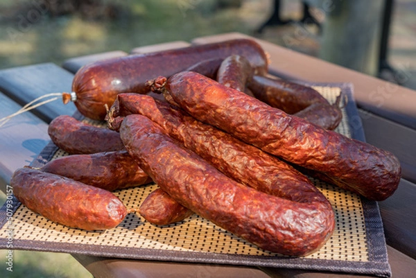 Fototapeta Diferent dried sausages on the table