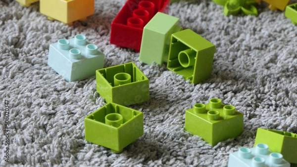 Fototapeta Mix of Colourful Pieces of Bricks sitting on mat indoors