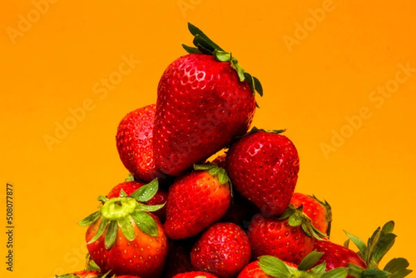 Obraz Fresh strawberries on orange background