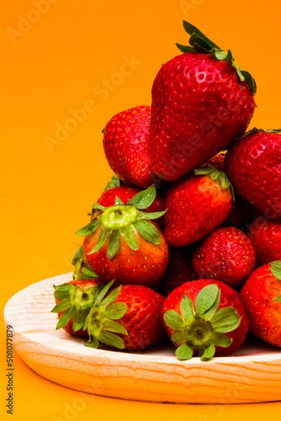 Obraz Fresh strawberries on orange background