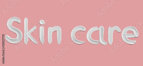 Obraz Skin care word written with cream texture smears on pink background