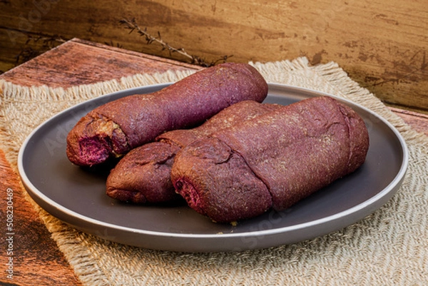 Obraz UBE Spanish bread - Isolated on wooden background with ample copy space, studio. lighting