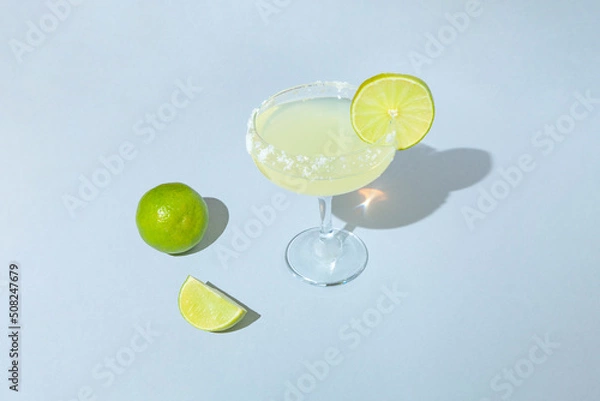 Obraz Minimal  composition with cocktail glass and fresh sliced lime. Summer refreshment concept