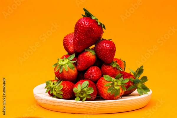 Obraz Fresh strawberries on orange background