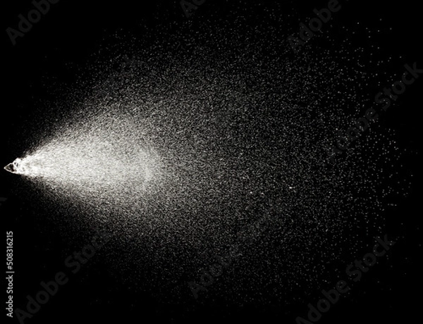 Obraz Sprayed water. Splashes and drops of water isolated on black background.