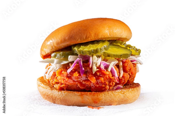 Fototapeta Spicy country fried chicken sandwich on a brioche bun with pickles and coleslaw; white background; copy space