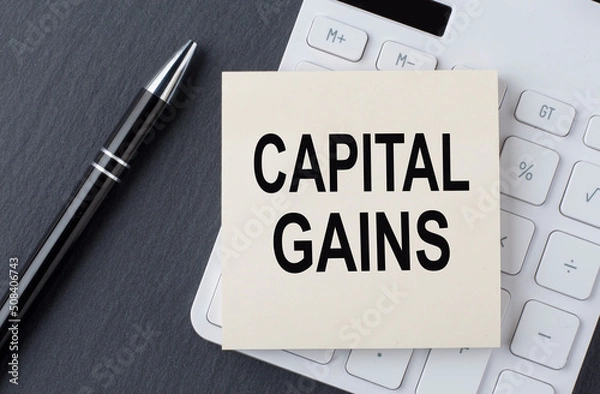 Fototapeta Text CAPITAL GAINS on the sticker on the calculator, business concept