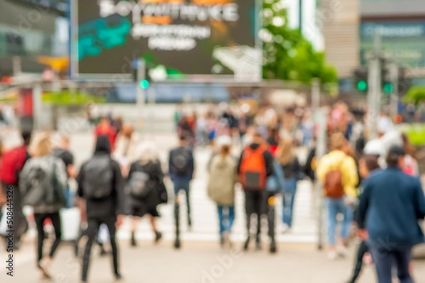 Fototapeta People crossing street in city, blurred view