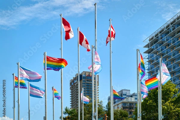 Obraz Gay Pride and Trans Pride Flags in Vancouver. Rainbow colored Gay Pride, Trans Pride, and Canadian Flags flutter in the wind beside English Bay in Vancouver’s West End Neighborhood. British Columbia,
